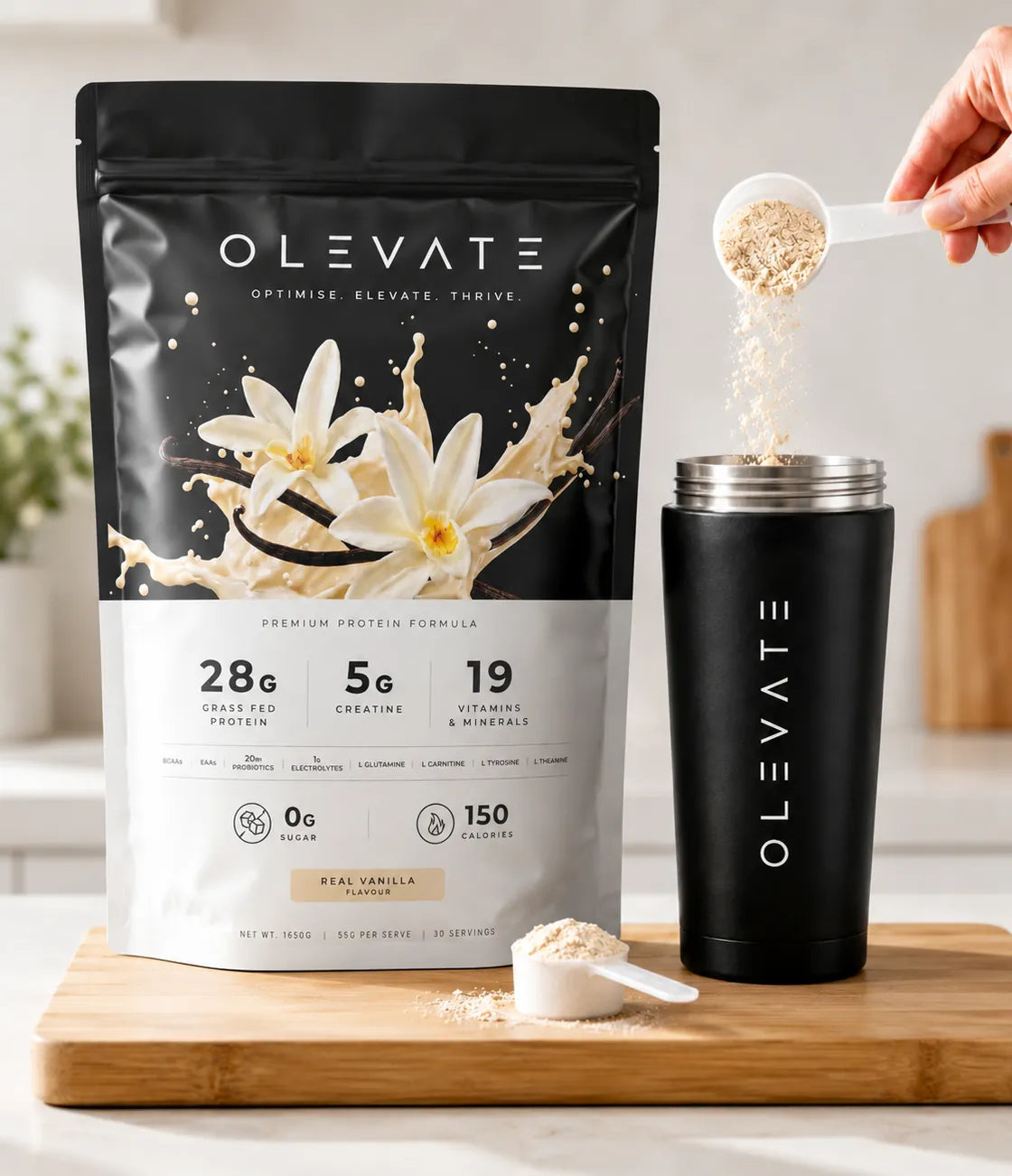 OLEVATE Complete Real Vanilla pouch on a kitchen bench beside a scoop of powder and the OLEVATE shaker